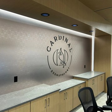 Interior of a medical office with 'Cardinal Dermatology' logo on the wall.