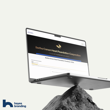 Computer screen displaying a website with 'Bertha Carson Heart Foundation Corporation' on a mountainous background, featuring Hayes Branding logo.